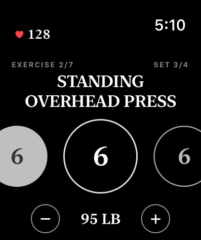 The watch mid-exercise: set circles, the weight, and live heart rate